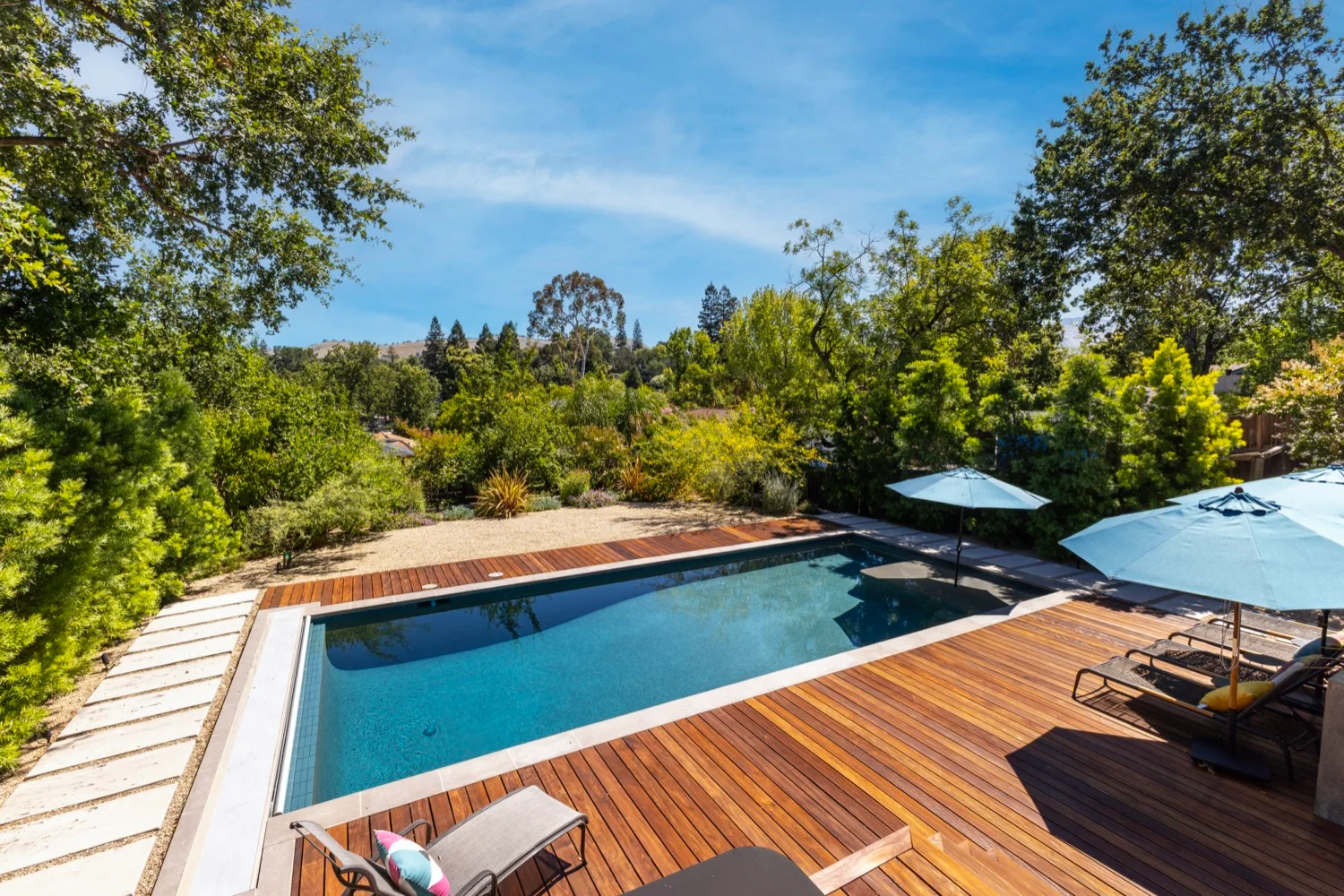 Hardwood decking and stone coping surrounding the San Miguel pool